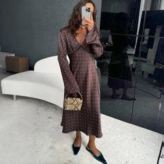 Model wearing brown polka dot v-neck dress