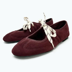 Burgundy faux suede round toe ballet flats with ribbon lace-up detail.