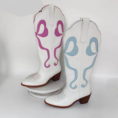 White cowboy boots with pink and blue designs on a white background