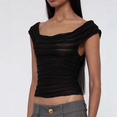 Black ruched top worn by a model on a white background