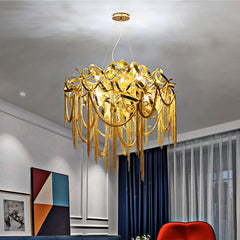 A luxurious French tassel chandelier with a golden finish illuminating a stylish living room. B