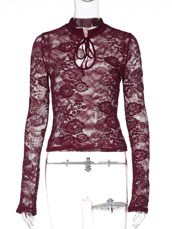 Maroon lace top on a mannequin against a white background
