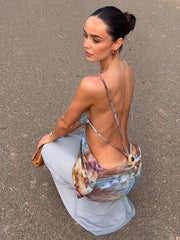 Woman wearing a patchwork cutout v-neck maxi dress while crouching