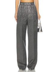 Close-up of the grey crystal-embellished trousers and a silver handbag.