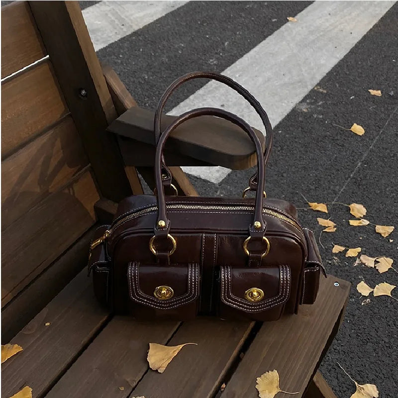 black and burgundy microfiber leather satchel with gold hardware