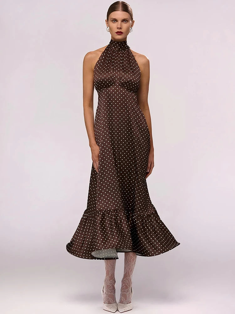 Woman wearing a brown polka dot dress on a white background