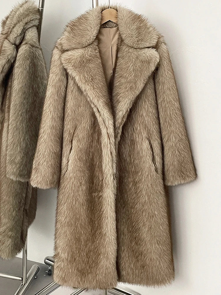 Beige faux fur coat on a hanger against a white background