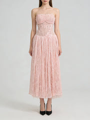 Pink strapless lace dress on a white background