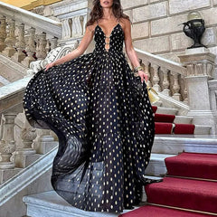 Woman in black and gold polka dot maxi Skirt on marble stairs