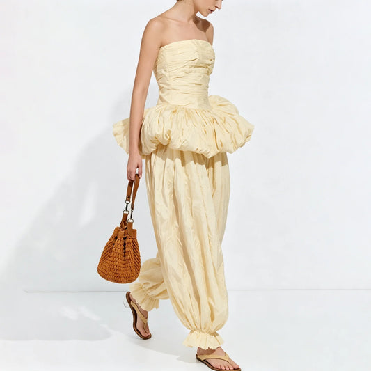 Model walking in a strapless ruched top and balloon pants set