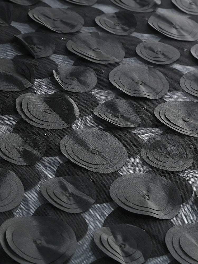 Pattern of black circular objects on a textured surface