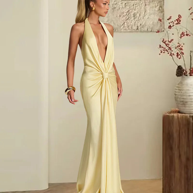 Woman wearing a yellow evening gown in an indoor setting.