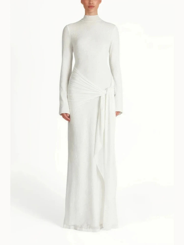 White long-sleeve gown with a draped design on a white background