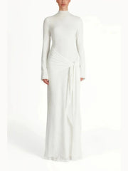White long-sleeve gown with a draped design on a white background