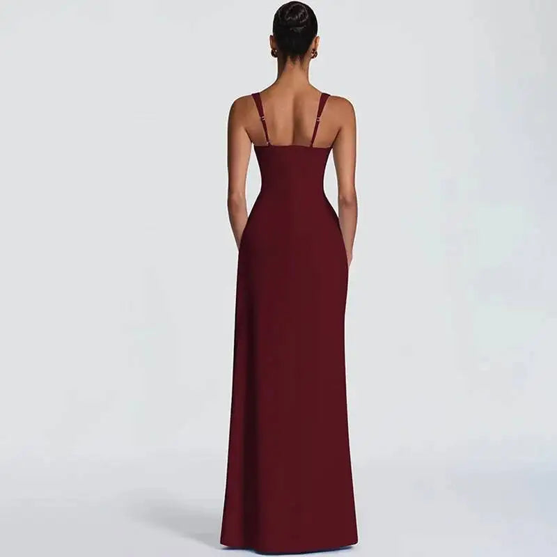 Woman wearing a burgundy evening gown on a light gray background