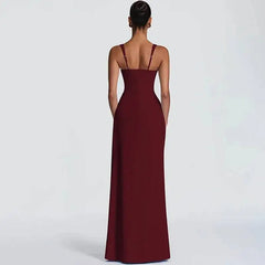 Woman wearing a burgundy evening gown on a light gray background