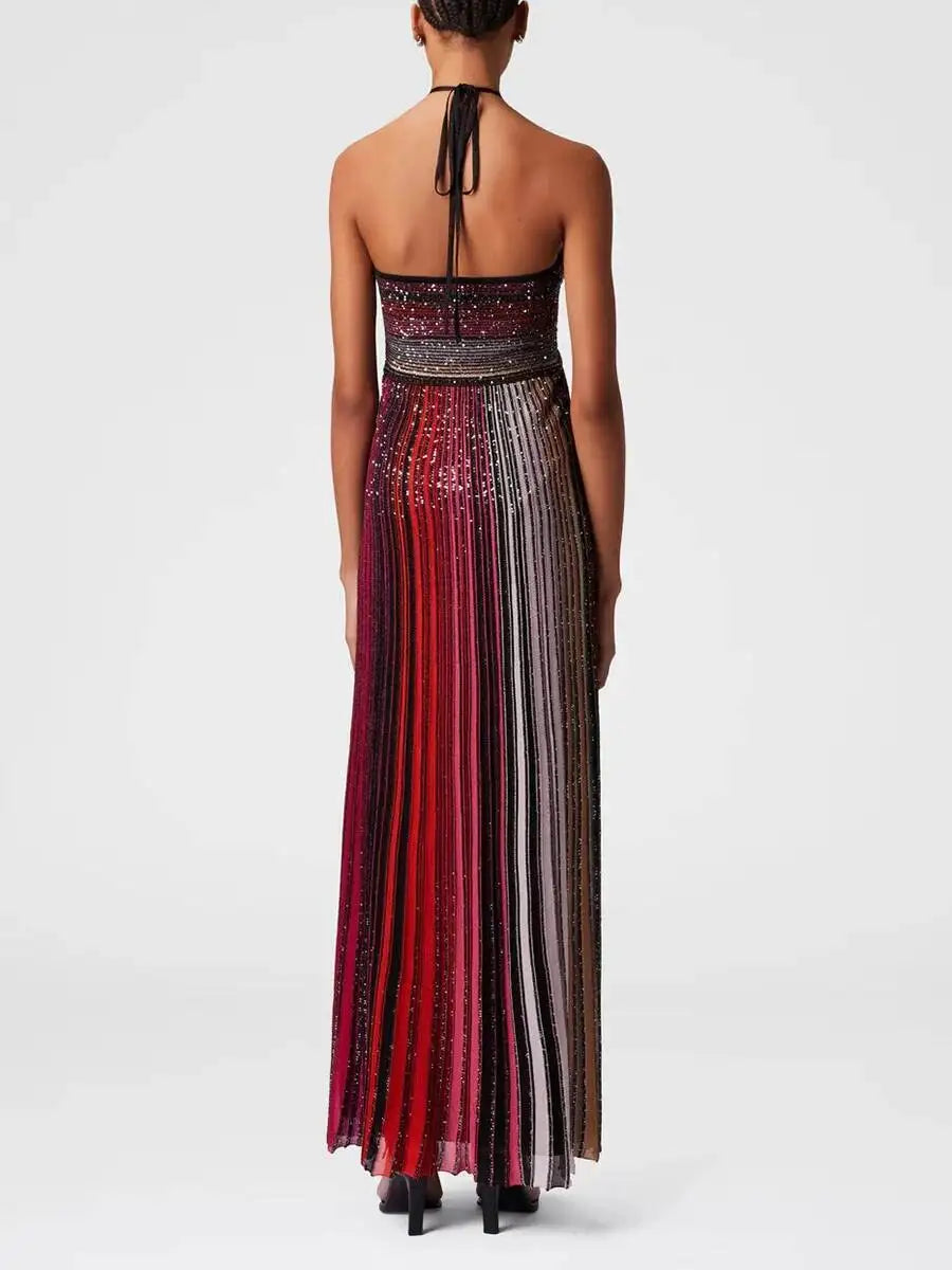 Woman wearing a long, patterned dress on a white background