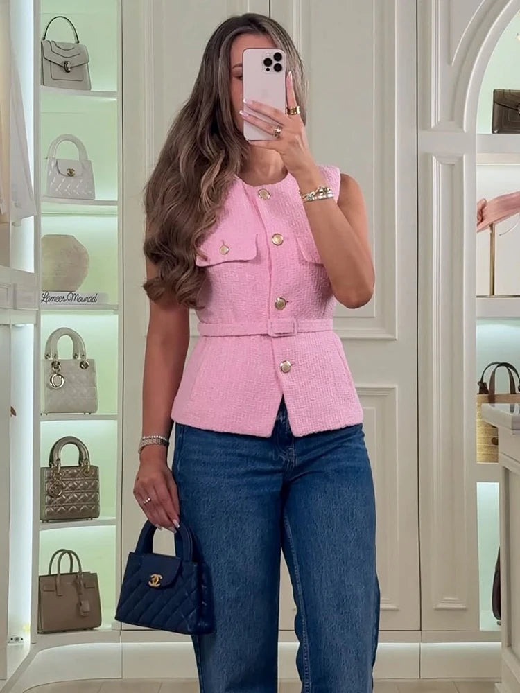 Pink tweed belted sleeveless top worn with jeans