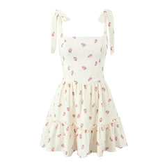 White dress with pink floral pattern on a white background