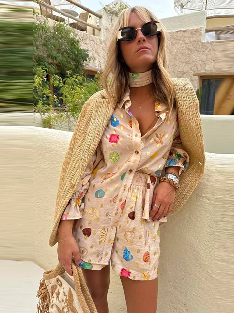 Woman in a colorful outfit with sunglasses and a straw bag outdoors.