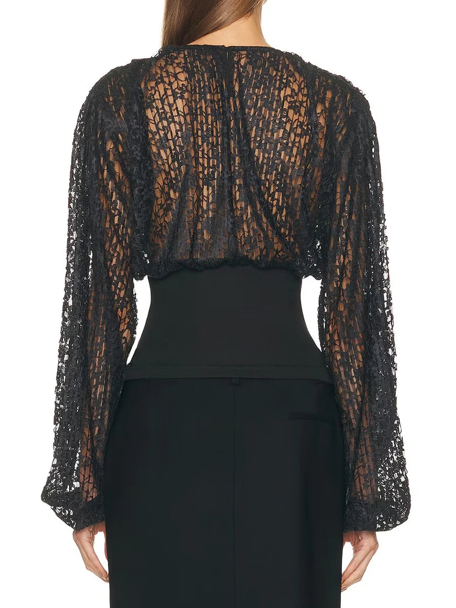 Black sheer blouse with long sleeves on a white background