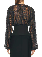Black sheer blouse with long sleeves on a white background