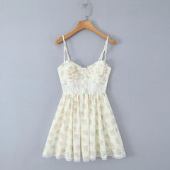 Floral dress on a wooden hanger against a gray background