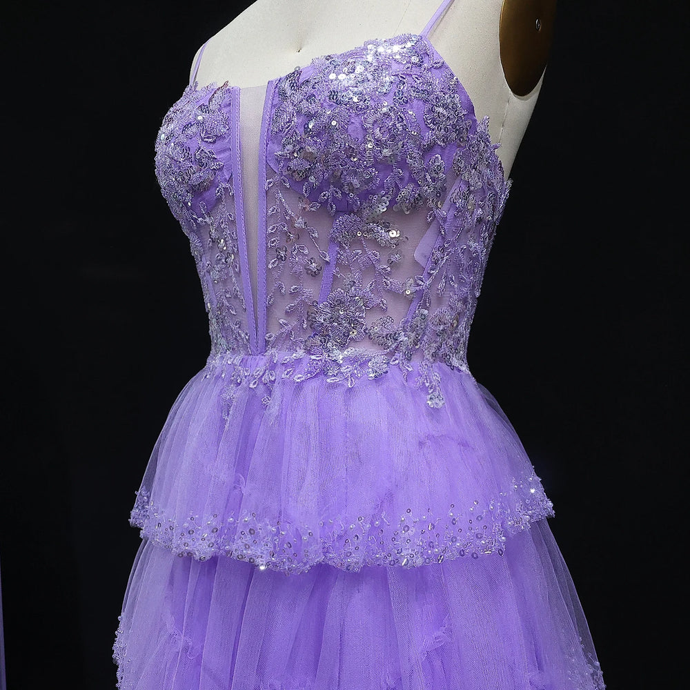 Purple evening gown with sequin detailing on a mannequin against a black background