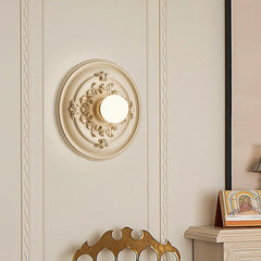 A round Art Deco wall sconce with a milk white glass shade, casting a warm glow . B