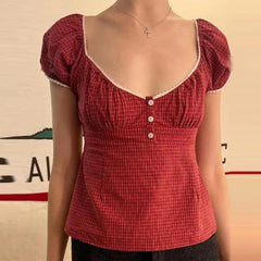 Red checkered top worn by a mannequin against a plain background