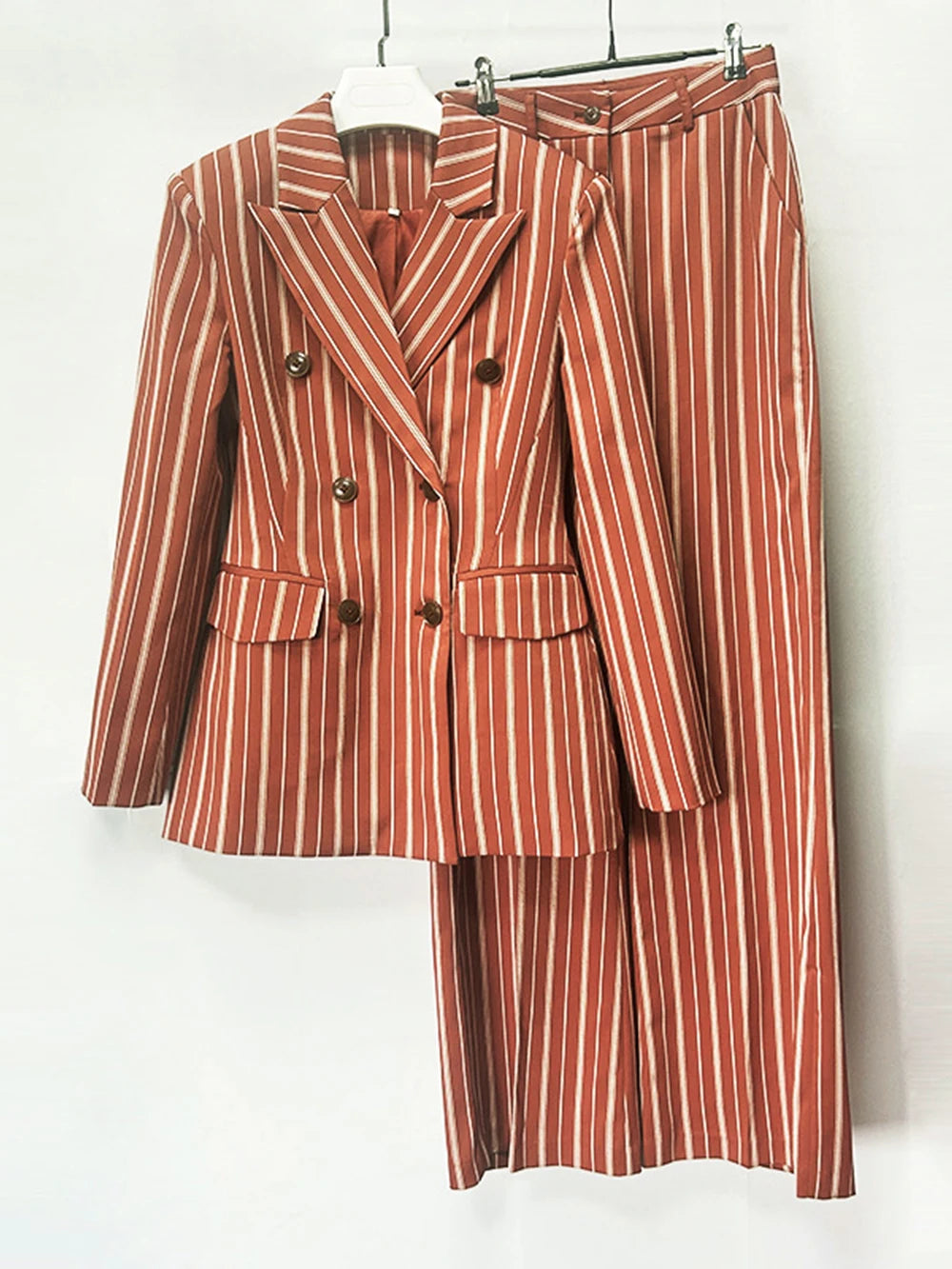 Double breasted striped blazer and wide leg pants suit hanging