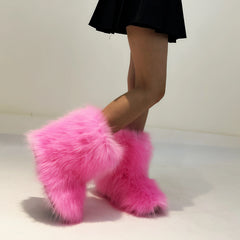 Woman wearing Fluffy Faux Fox Fur Winter Boots from Golden Atelier, showcasing the full boot and fur details.