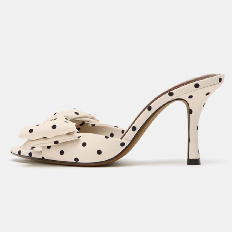 Polka dot high-heeled shoe on a white background