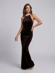 Woman wearing a brown evening gown on a gray background