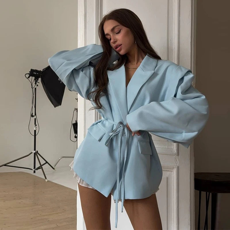 Woman wearing a light blue robe in a studio setting