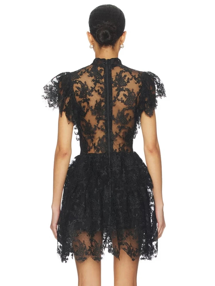 Back view of black lace mini dress with high neckline and zipper closure