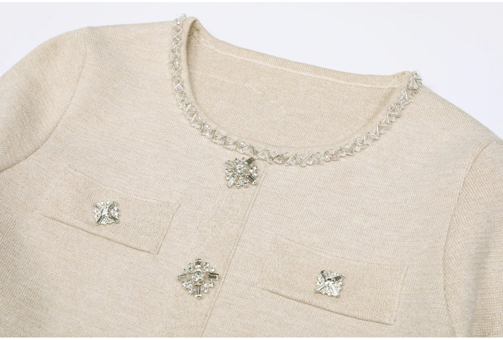 Close-up of the neckline and buttons on a beige knit cardigan