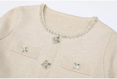 Close-up of the neckline and buttons on a beige knit cardigan