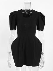 Black dress on a mannequin against a white background