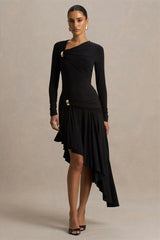 Woman wearing a black dress with long sleeves and an asymmetrical skirt on a beige background