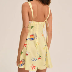 Yellow dress with colorful patterns on a plain background