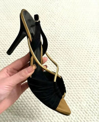 Side view of black and gold stiletto heeled sandals
