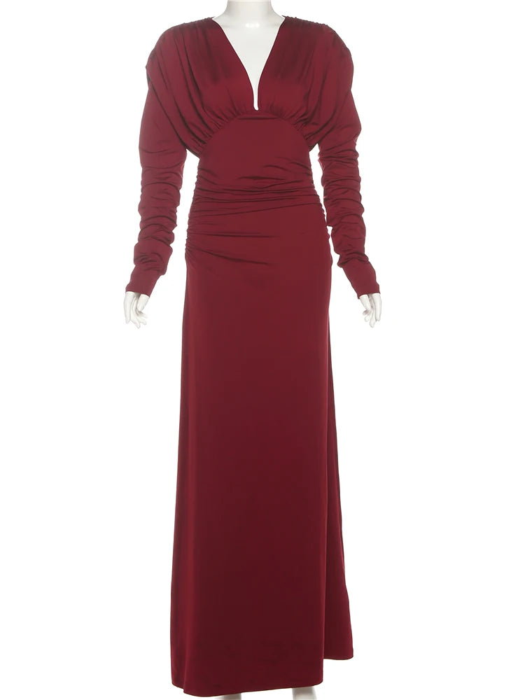 Maroon evening gown on a mannequin against a white background