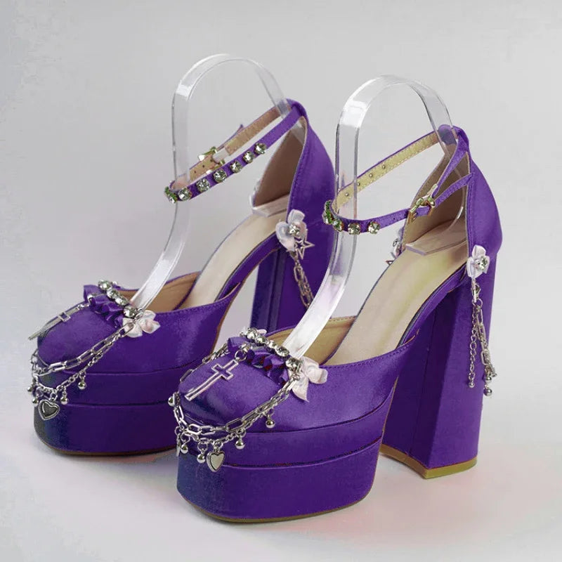 Purple high-heeled shoes with decorative chains on a light gray background