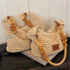 Two woven bags with wooden bead handles on a black surface.