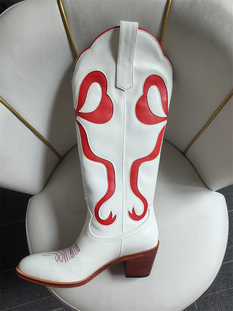 White cowboy boot with red designs on a white chair