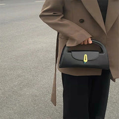 A woman carrying the crossbody bag, highlighting its versatility and edgy style. Golden Atelier 3