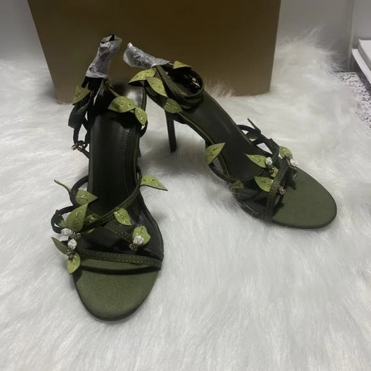 Side view of green leaf embellished stiletto heels