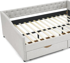 White upholstered bed with wooden slats and drawers on a white background