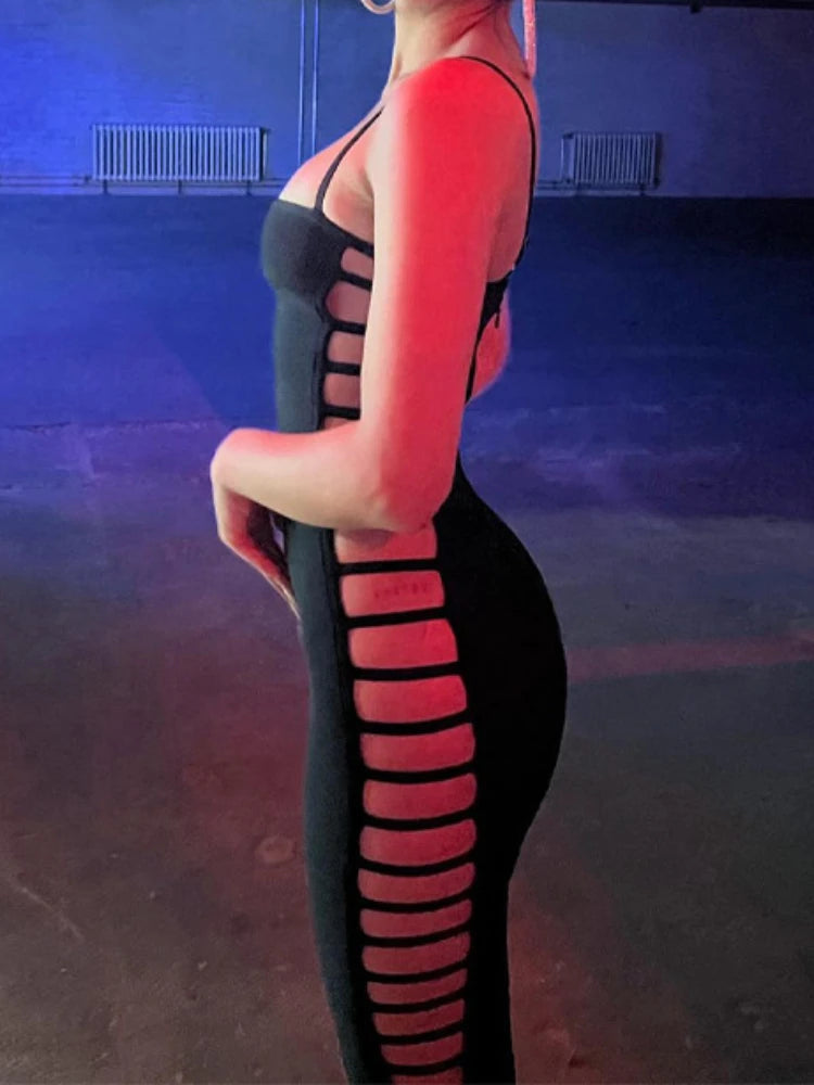 Person wearing a black and red outfit with a unique design on a blue background